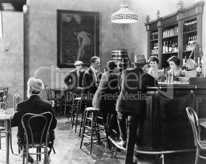 Men sitting around a counter in a bar