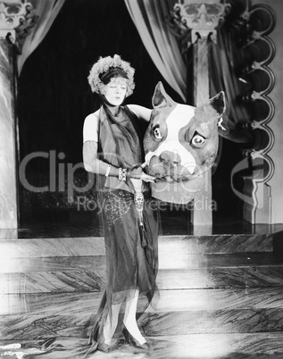 Young woman holding a giant dogs head