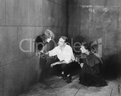 A priest and a man trying to help a young woman escape