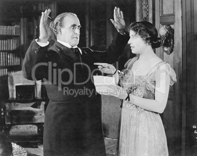 Woman with a letter in her hand pointing at a man