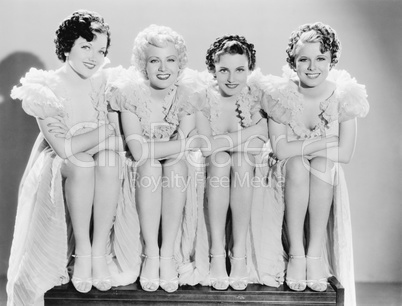 Four woman sitting together and posing