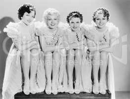 Four woman sitting together and posing