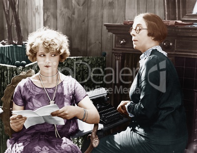 Two women sitting together working