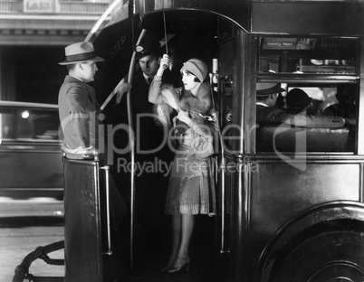 Young woman riding a bus flirting with a young man
