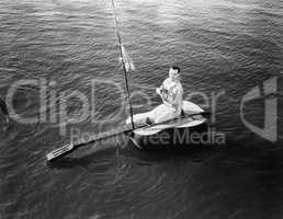 Man sitting on a guitar sailboat