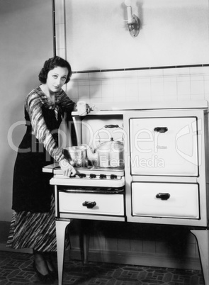 Woman next to her stove in the kitchen