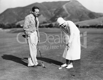 Couple playing golf together