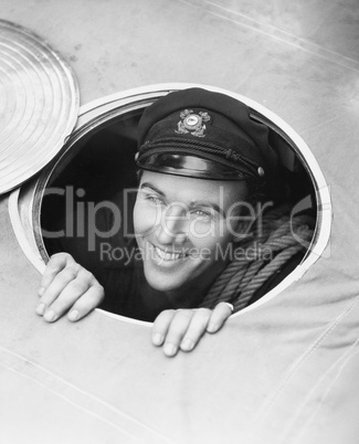 Sailor looking up through hole