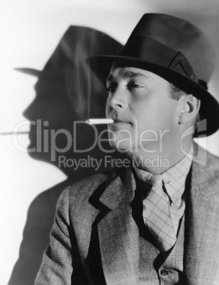 Portrait of a man in a fedora with a cigarette in his mouth