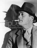 Portrait of a man in a fedora with a cigarette in his mouth