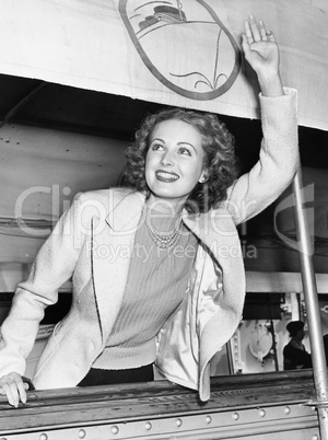 Woman on a ship waving