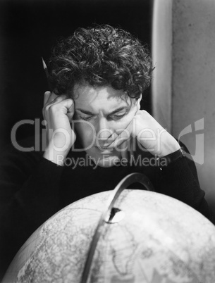 Man studying the globe
