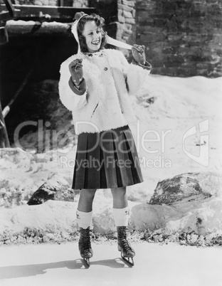 Woman with ice skates on a pond