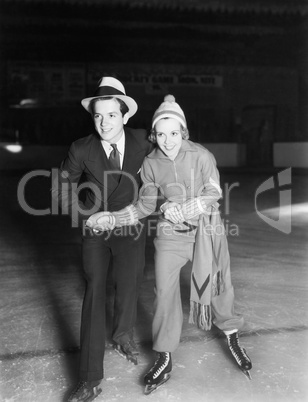 Young couple ice skating together