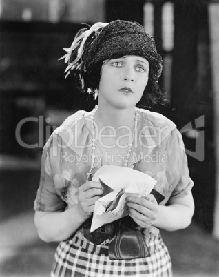 Woman looking unhappy after receiving a letter