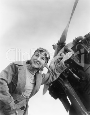 Woman standing next to her plane