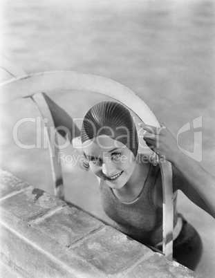 Woman climbing out of a pool