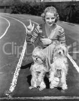 Woman with her two dogs on a race track