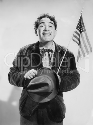 Man with the American flag in his hand smiling