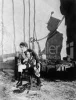 Uniformed man sitting in a prison chained