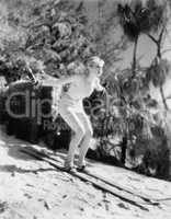 Woman In a bathing suit skiing down a hill