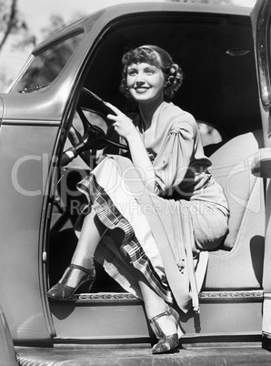 Woman sitting in a car behind the steering wheel