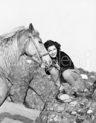 Woman hugging her horse