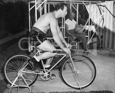 Man sitting on a stationary bicycle doing exercise