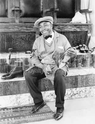 Shoeshine man working and smiling