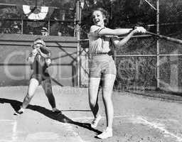 Two women playing baseball