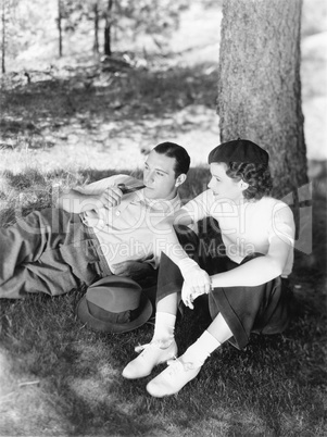 Couple sitting under a tree