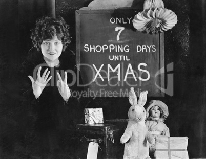 Woman and sign with number of shopping days until Christmas