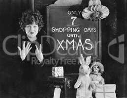 Woman and sign with number of shopping days until Christmas