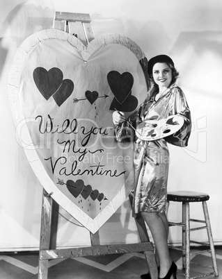 Woman painting huge valentine