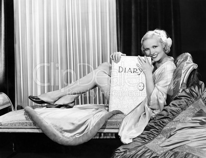 Woman posing with large diary