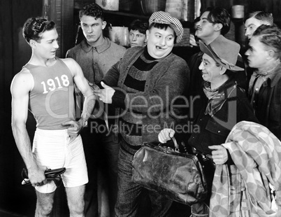 Group of men looking at an athlete