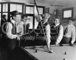 Group of men playing snooker