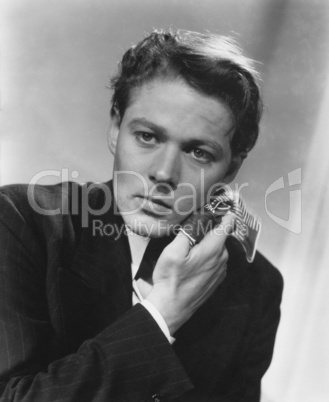 Close-up of worried man wiping face with handkerchief