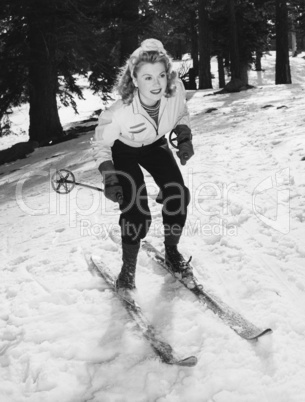 Woman on skiis with knees bent