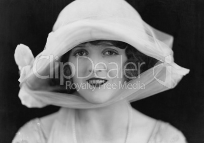 Close-up of smiling woman in hat