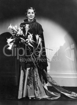 Portrait of smiling woman holding flowers