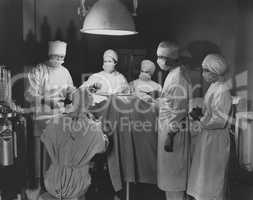 Team of surgeons perform operation
