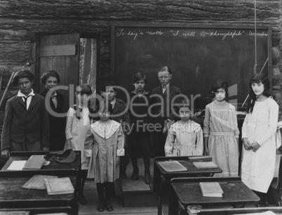 Group portrait of children standing in classroom