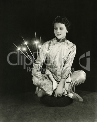 A woman holds sparklers