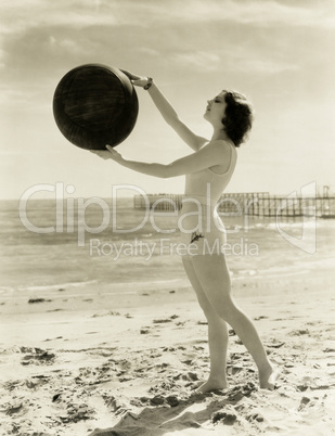 Balancing a medicine ball on the beach