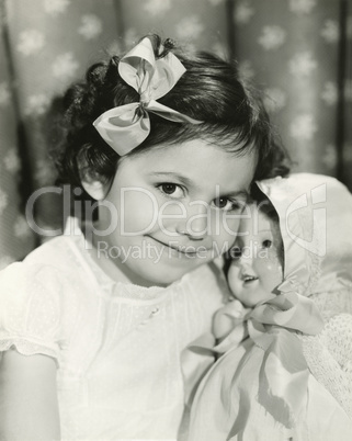 Little girl posing with her doll