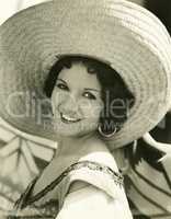 Smiling under her straw hat