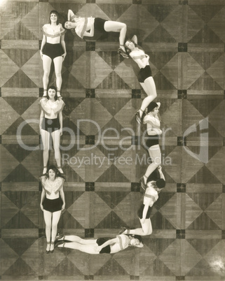 High angle view of women forming the letter "D"