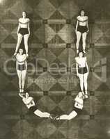 High angle view of women forming the letter "U"
