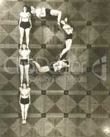 High angle view of women forming the letter "P"